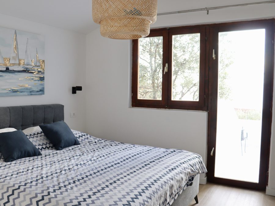 Bedroom with double bed and window opening to the garden