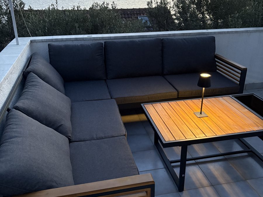 Terrace lounge seating at sunset, overlooking the sea